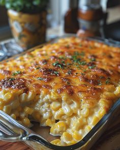 a casserole dish with macaroni and cheese in it on a wooden table