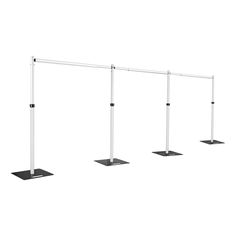 three white poles with black square bases on each side, and one pole has two feet that are not parallel to the ground