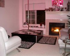 a living room with white furniture and pink walls