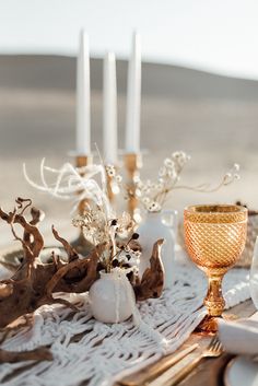 a table topped with white and gold place settings