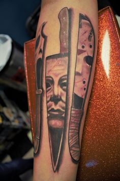 a man's arm with two knives and a face on the inside of it