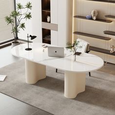 a white table with a laptop on it in a room