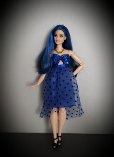 a doll with blue hair wearing a dress