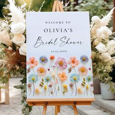 an easel with a sign that says, welcome to ollivia's bridal shower