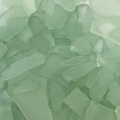 green sea glass is piled on top of each other