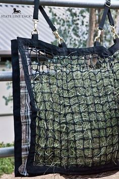 a bag with hay in it hanging from a rail