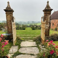 an outdoor garden with two gates and flowers