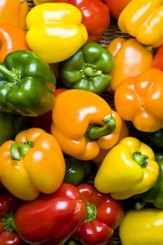 many different colored peppers on display together