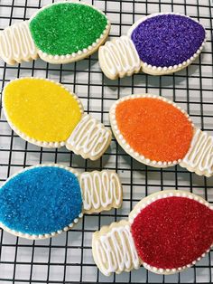 decorated cookies with different colors on a cooling rack