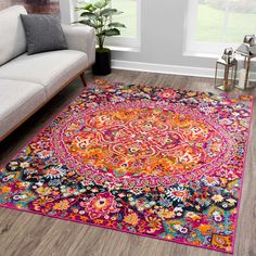 a living room with a white couch and colorful rug