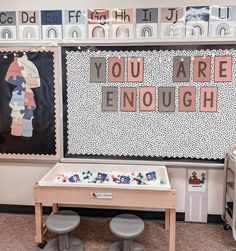 two stools sit in front of a table with letters on it and the words you are enough