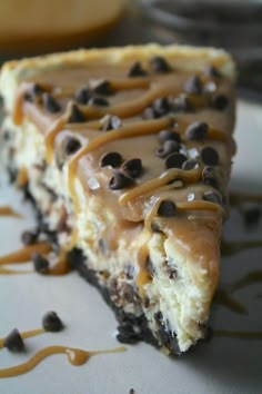 a piece of cheesecake with chocolate chips and caramel drizzle