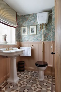 a bathroom with an old fashioned toilet and sink