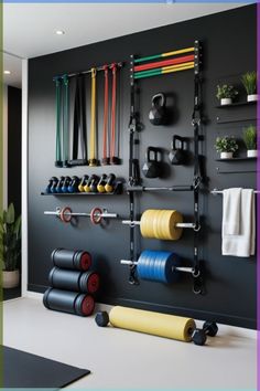 a wall mounted gym equipment in a room with black walls and white flooring on the side