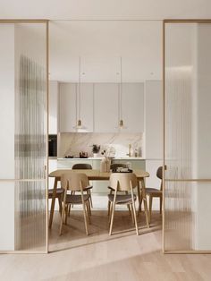 an open kitchen and dining room with sliding glass doors on the wall to let in natural light