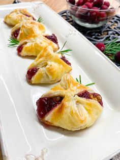 cranberry and cheese pastries on a white platter