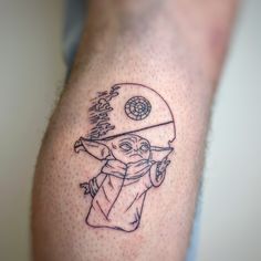 a man with a tattoo on his arm has a baby yoda holding a baseball bat