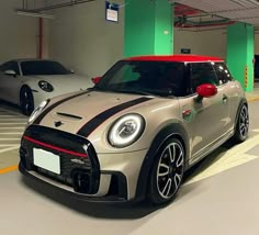 two cars parked next to each other in a parking garage with green and white walls