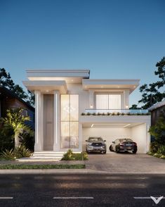 two cars are parked in front of a modern house at night with the lights on