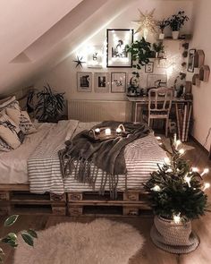 an attic bedroom is decorated with plants and lights