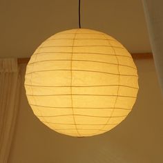 a white paper lantern hanging from the ceiling