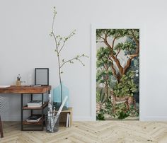 a room with two paintings on the wall and a wooden table in front of it