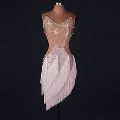 a mannequin wearing a dress with sequins and feathers on it's back