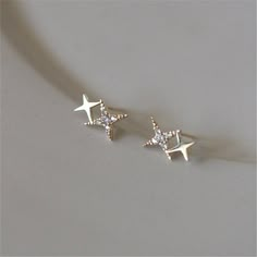 Dainty celestial sparkle; need more convincing? These Sparkle Star Stud Earrings are guaranteed to become your new everyday go-to studs. DETAILS & SIZE Composition: 14K gold plated over .925 sterling silver or solid .925 sterling silver; CZ stones Measurements: 9x5.5mm Comes with push back ear nuts Read about how to care for our jewelry here. Shop the Celestial collection for more options! Or shop Earrings for more options! Stud Earrings Women, Dainty Gold Earrings, Gold Jewelry Gift, Star Stud Earrings, Gold Number, Star Earrings Stud, Star Jewelry, Earrings Women, Delicate Jewelry