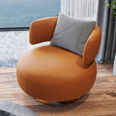 a chair with a pillow on top of it in front of a window overlooking the mountains