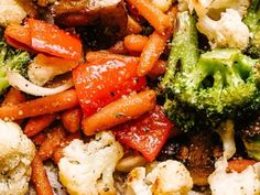 broccoli, cauliflower, and carrots are mixed together on a plate