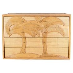 a wooden box with a palm tree on the front and bottom panel, made out of bamboo