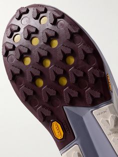 the sole of a shoe with yellow dots on it