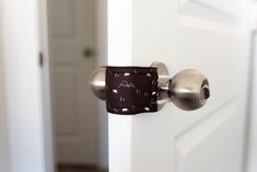 a close up of a door handle on a white door with an animal print pocket