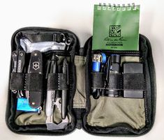 the contents of an outdoor survival kit are neatly packed in a carry - on bag