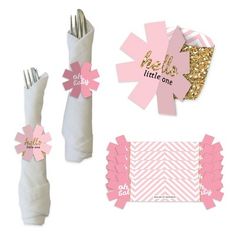 pink and gold baby shower party supplies including napkins, candy wrappers, place cards