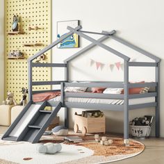 a child's loft bed with a slide in the middle and a rug on the floor