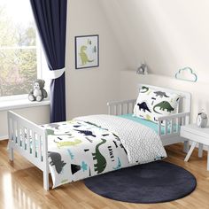 a child's bedroom with dinosaur bedding and blue curtains