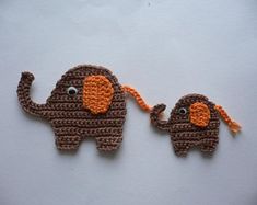 two crocheted elephants are holding each other's strings