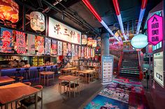 the interior of a restaurant with many colorful signs on the walls and tables in front of them