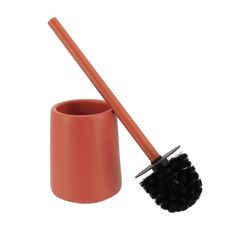 an orange cup with a brush in it