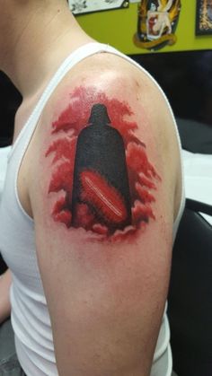 a person with a red and black tattoo on their arm