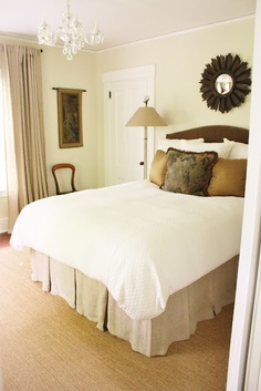 a bedroom with a large bed and chandelier