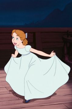 a woman in a white dress is dancing on a wooden floor with mountains in the background