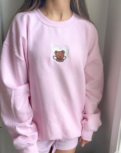 Stay comfy all season long in the perfectly oversized Cupid Bear Crewneck Sweatshirt. This sweatshirt features long sleeves, a crew neckline, and beautiful front embroidery. The Unisex Sizing makes the sweatshirt run slightly larger than your average sweatshirt for women. Most men find their normal size to be more snug. If you want a slightly looser fit, size up one size. Please check out our size chart for measurements to ensure an accurate fit. PLEASE BE SURE TO INPUT YOUR CORRECT SIZE/COLOR + Pretty Pajamas, Sweatshirts Aesthetic, Light Pink Sweatshirt, Pretty Sweatshirts, Crewneck Outfit, Embroidery Crewneck, Kawaii Sweatshirt, Colorful Sweatshirt, Sweatshirt Aesthetic