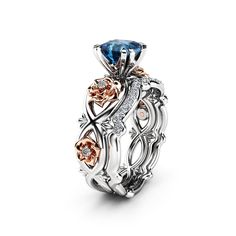 an intricately designed engagement ring with blue topaz