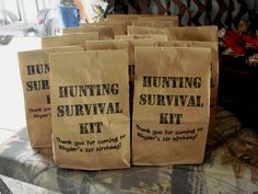 several brown paper bags sitting on top of a table next to each other with writing on them