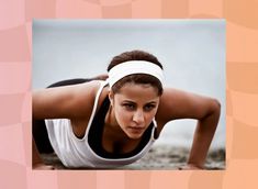 a woman is doing push ups on the ground with her hands behind her head and looking at the camera