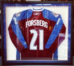 a jersey is displayed in a glass case