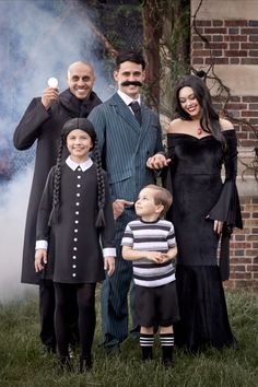 a group of people dressed in costumes posing for a photo with a child and an adult