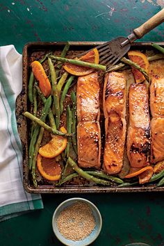 salmon, green beans and oranges on a baking sheet